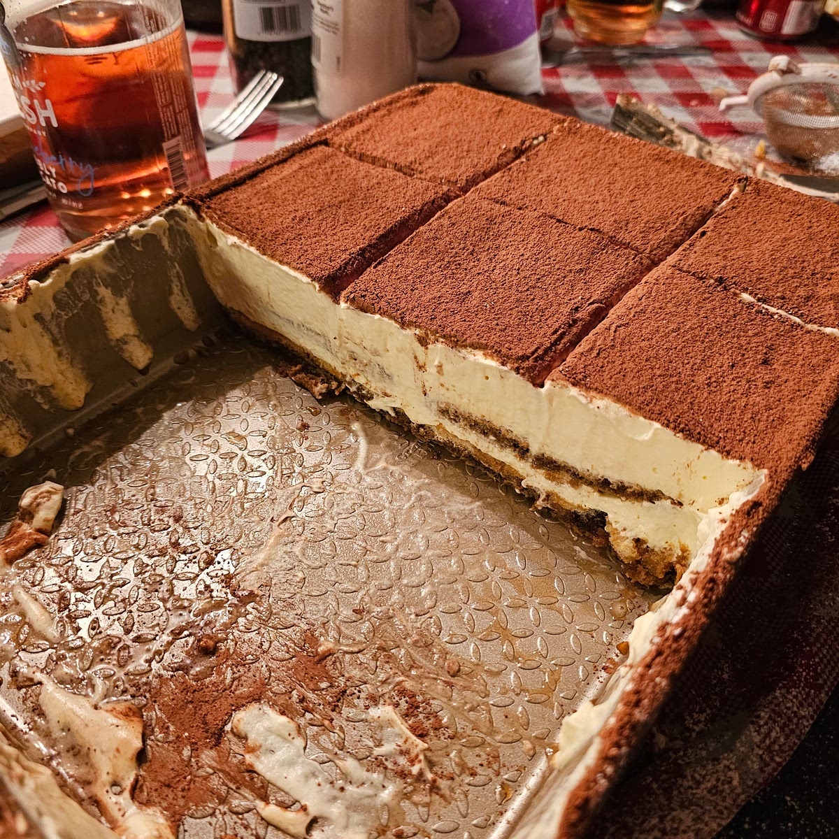 When you're ready to serve. Dust a generous layer of powered sugar, and then a generous layer of coco powder. You want to do this just before you serve because it will absorb the moisture of the cake if you put it on too early. It's very tricky to scoop the slices out of a baking pan, you will want to use a thin flat spatula.