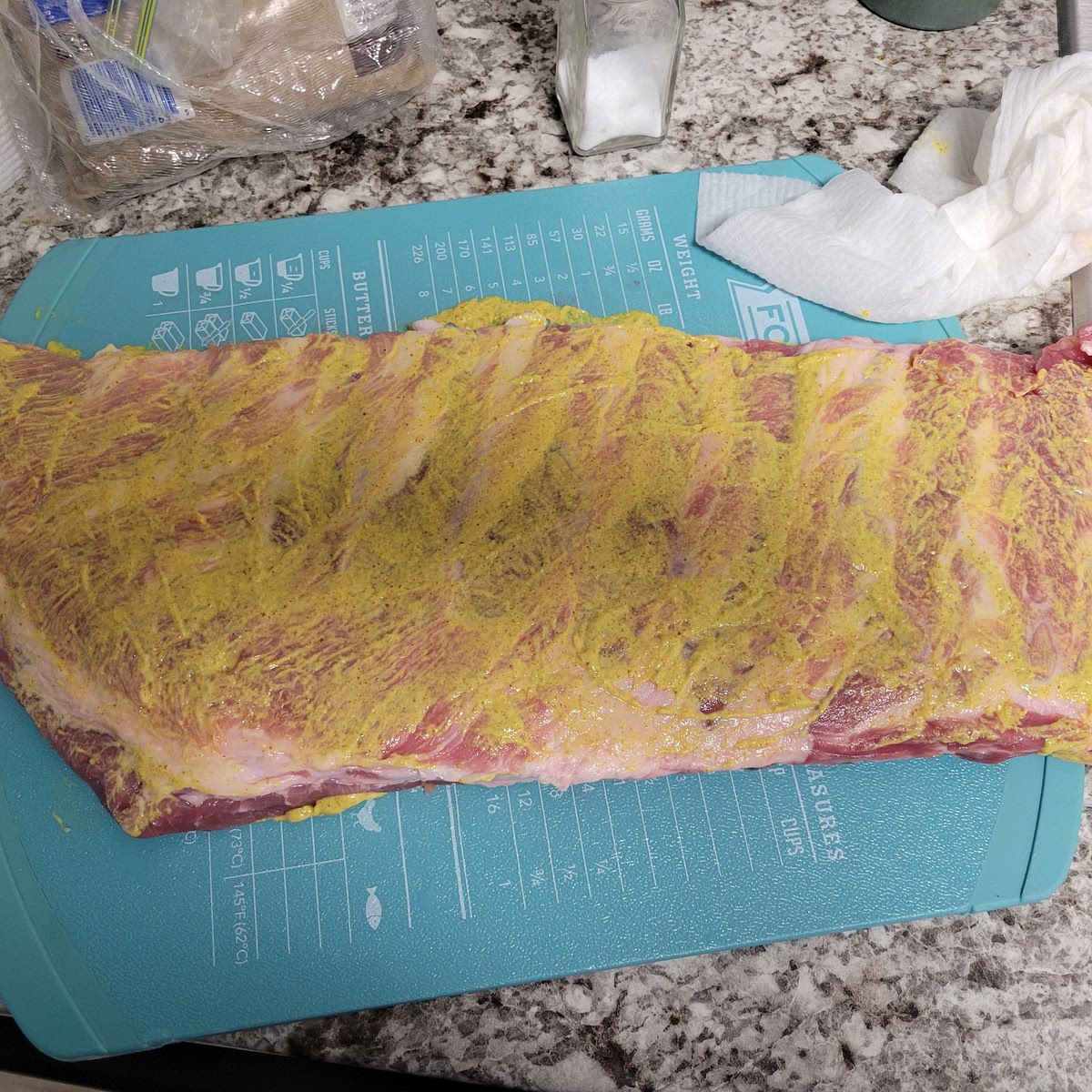 Rub in 3oz of your choice of mustard to each side of the ribs. I used spicy brown mustard. It just needs to be a thin layer. All we want is to create a binding for our seasonings.