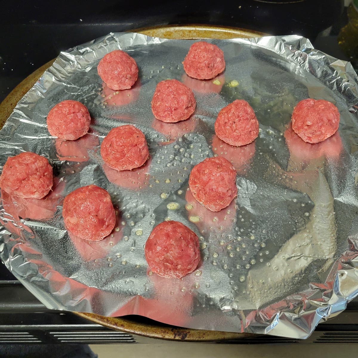 Roll ground beef into 3oz balls or just ensure the meat balls are all the roughly the same size. The bigger the meatball the longer the cook time, and the dryer they could become.
Roll your preformed meatballs gently in the bowl of panko before setting on a oven pan placing them at least a 1/2 inch apart. Set timer for 5 minutes.