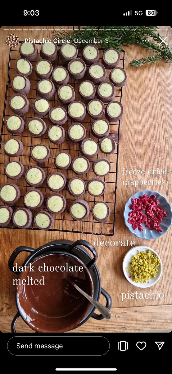 Melt dark chocolate and dip cookies in. then decorate! (Original used freeze dried raspberries and pistachios)