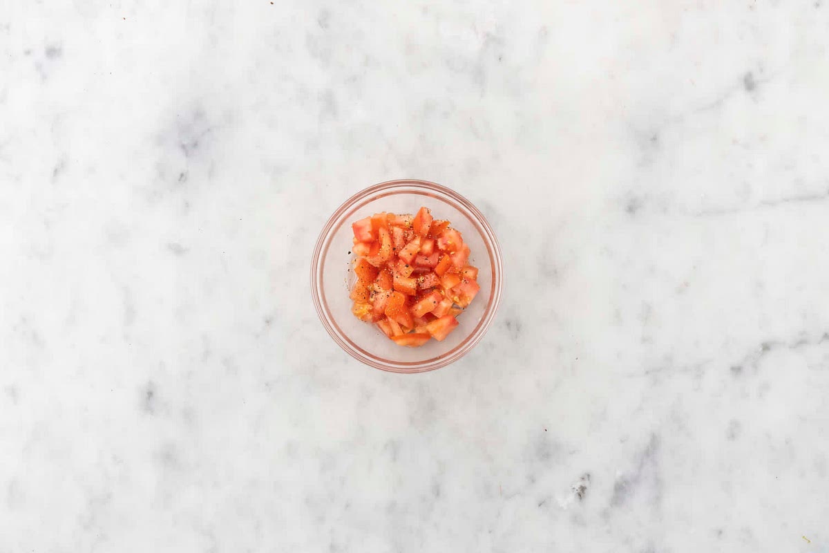 a) Meanwhile, cut the tomato into 1cm chunks.
b) In a medium bowl, combine the tomato, sugar and olive oil (see pantry for both amounts). Season with salt and pepper, then set aside.