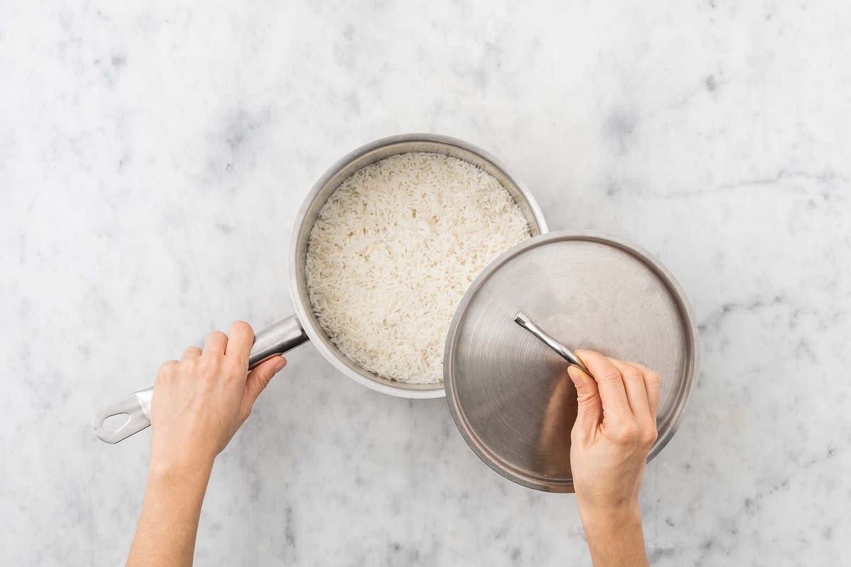Boil a half-full kettle. Pour it into a saucepan with 1/4 tsp salt on high heat.
Boil the rice, 10-12 mins. Once cooked, drain, pop back in the pan and cover.
Meanwhile, heat a frying pan on medium-high heat.