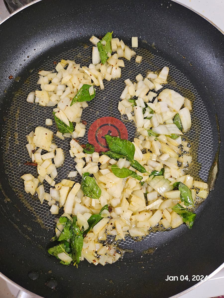Keep the fish aside. To the same pan, add more oil. Add in the curry leaves and chopped onion. Saute till golden.