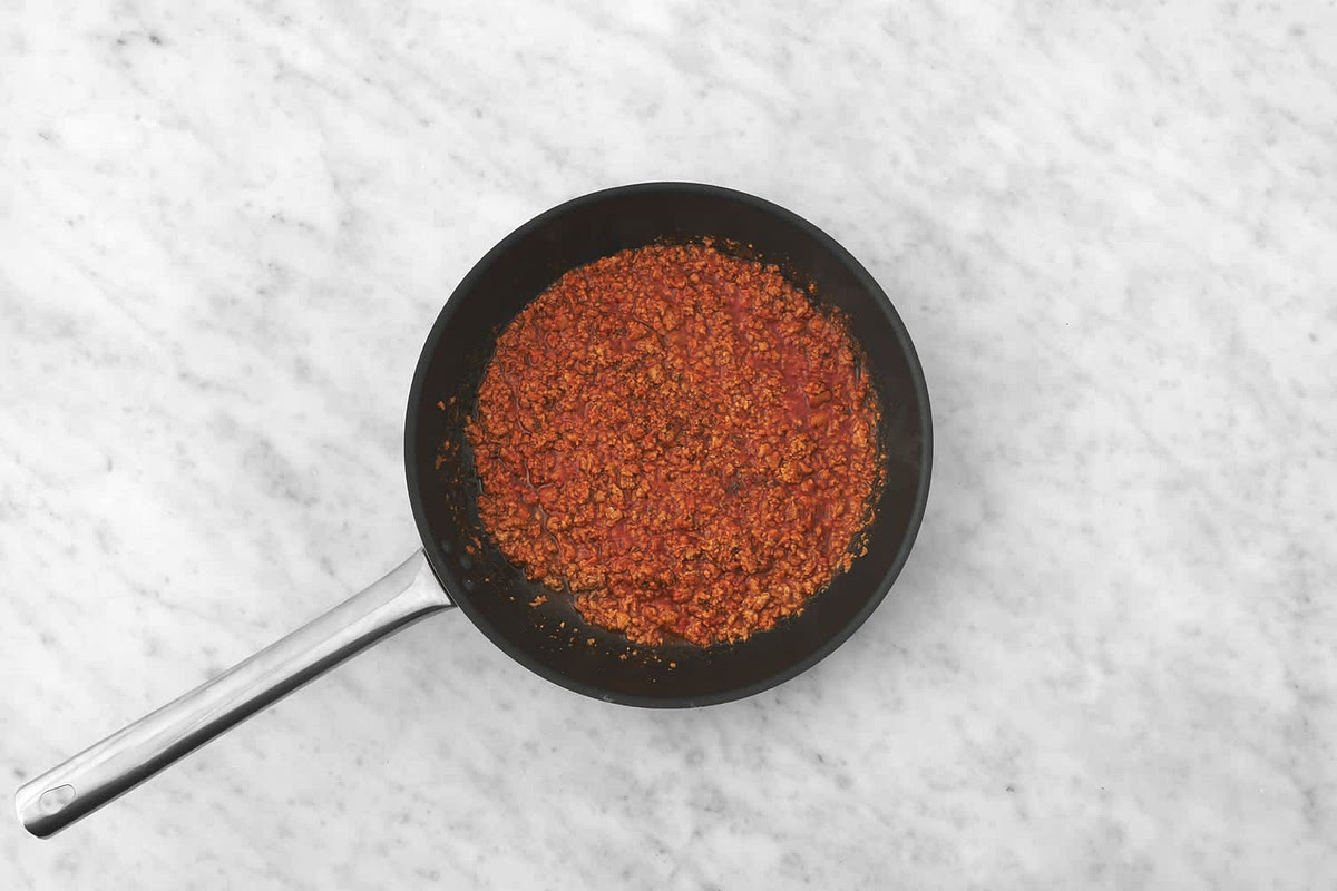 Drain the fat from the mince. Season with salt and pepper.
Add the tomato puree, Central American spice mix, chicken stock paste and water (see pantry). Fry until the sauce has thickened, 2-3 mins. Remove from the heat and stir in the ketchup (see pantry).
Add a splash of water if it's too thick. Taste and season with salt and pepper if needed.