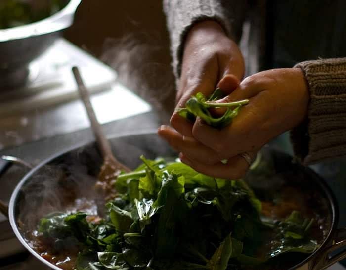 Add spinach, coriander, and mint; stir well. Turn the heat off and let sit for 5 to 10 minutes to allow cinnamon to infuse more, if using sticks. Remove bay leaves and cinnamon stocks. Serve over couscous with lemon wedges. Garnish with mint and coriander leaves.