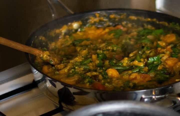Add veggies (except spinach), raisins, and salt. Simmer 15 more minutes. If making couscous, now is a good time to add hot water to your couscous so it'll be soft and fluffy by the time the tagine is finished.