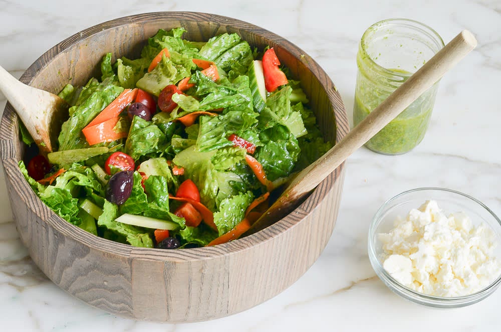 Place all salad ingredients in a large bowl. Right before serving, add about half of the dressing and toss well. Add more dressing little by little as necessary; be sure to dress greens very generously, otherwise salad will be bland. Taste and adjust seasoning with salt and pepper. Reserve the leftover dressing for another use.
