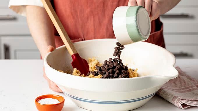 Stir in flour mixture just until blended (dough will be stiff). Stir in chocolate chips and nuts.