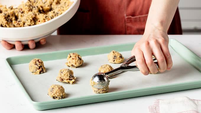 Onto ungreased or parchment-lined cookie sheets, drop dough by rounded tablespoonfuls 2 inches apart.