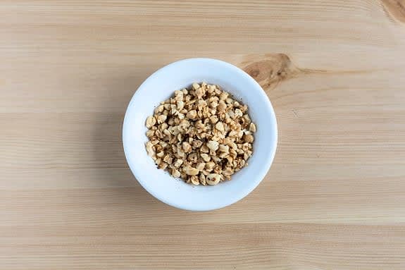 Toast the peanuts
In the same pot, heat a drizzle of oil on medium-high. Add the sesame seeds, peanuts, ½ the garlic and S&P. Toast, stirring occasionally, 1 to 2 min., until lightly browned and fragrant. Transfer to a small bowl. Wipe out and reserve the pot.