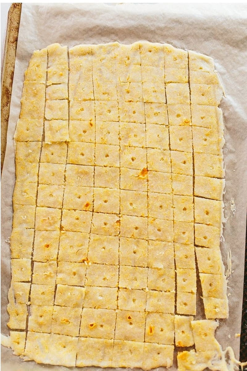 Take out of the oven and score a grid of lines with a sharp knife to create the shapes of the cracker, they don’t need to be perfectly cut or cut 100% through, you will break apart after cooking.