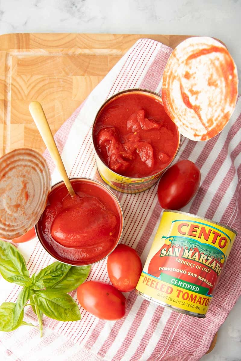 Pour the San Marzano tomatoes into a dish and crush them with your hands. Using a blender is not recommended as this will break the seeds which inturn makes the sauce bitter. Add the tomatoes and the puree to the pan