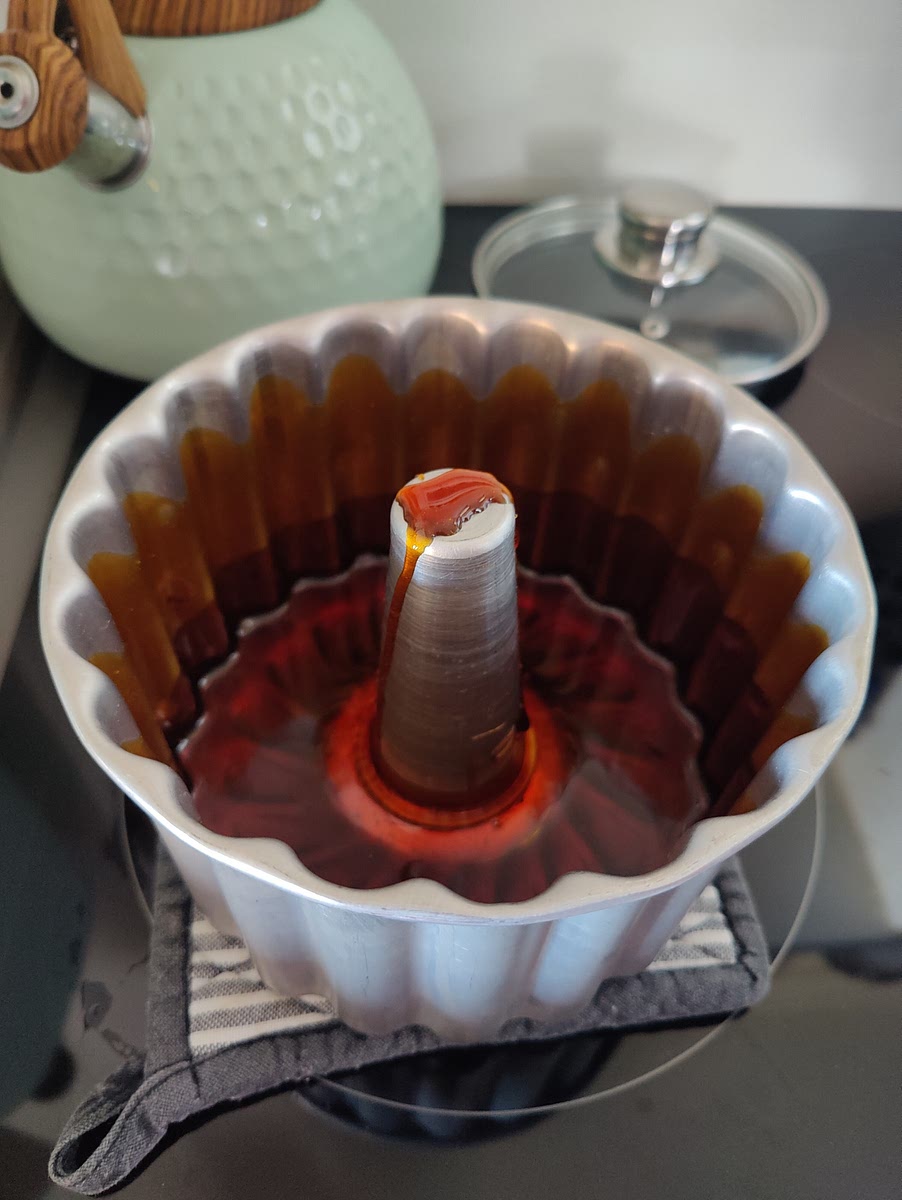 Slowly pour the sugar into the Portuguese flan dish. (See image)