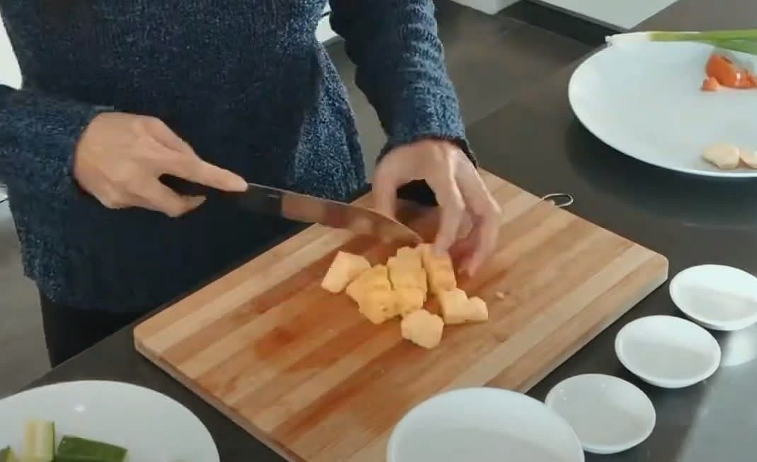 Chop pineapple into squares.