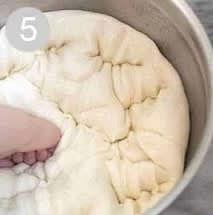 Punch the dough down well to remove air bubbles. Divide into two equal portions. Shape each ball into long logs and place into greased loaf pans.