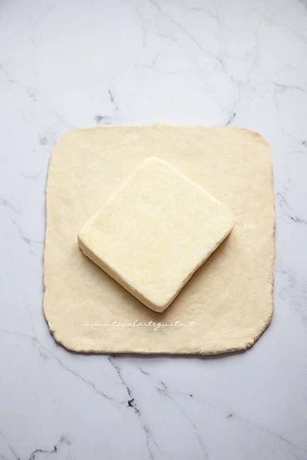 Posizionate il burro al centro dell’impasto lasciando 4 cm dai bordi: