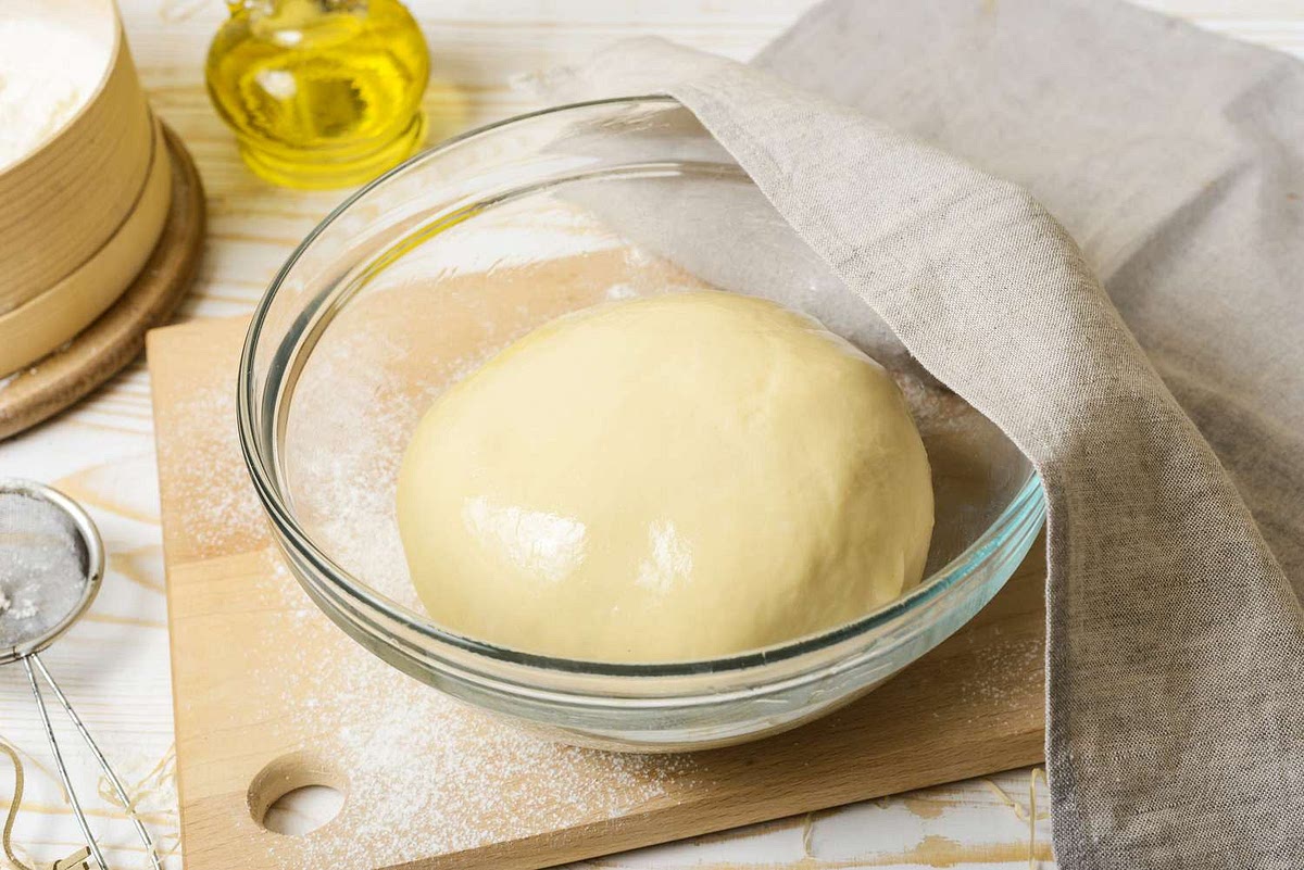 Knead on the counter just until the flour is used up and place in a well oiled bowl and cover with a damp cloth, letting it rest at room temp for an hour.