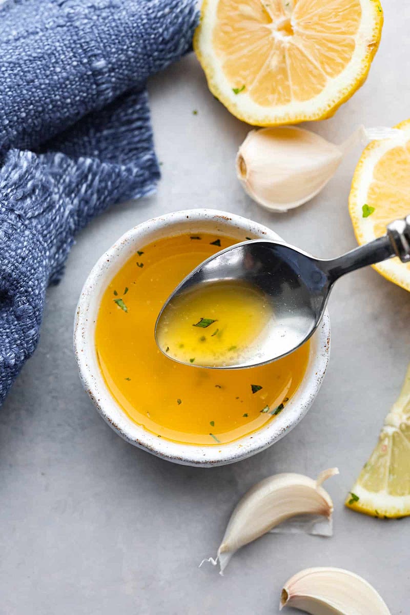 Add a teaspoon of your garlic Butter mix on one side of your naan and let rest.