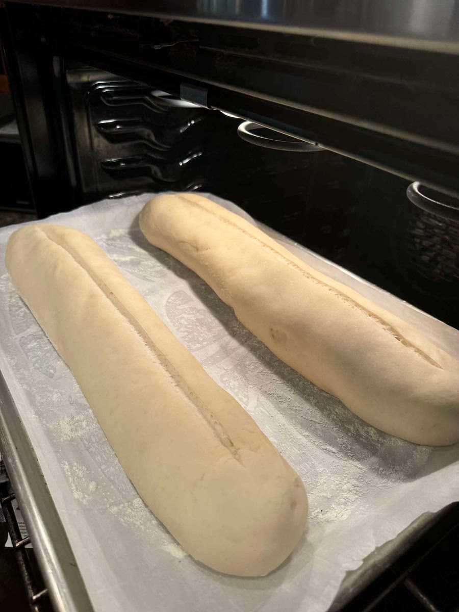 Once the loaf has doubled in size take a razor or sharp knife and cut a thin slit along the entire top of the loaf.