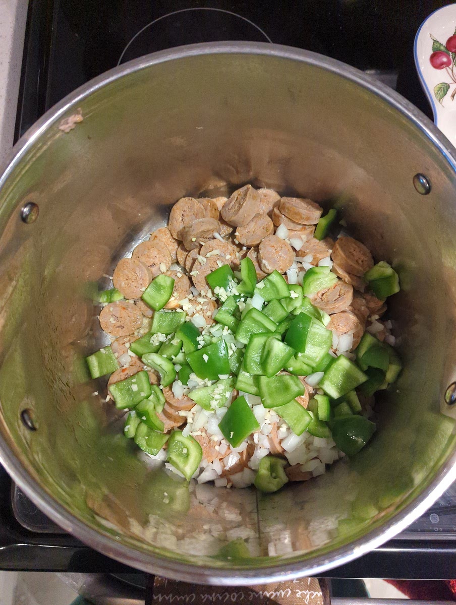 Put sausages back in pot, as well as green peppers, onion, and garlic