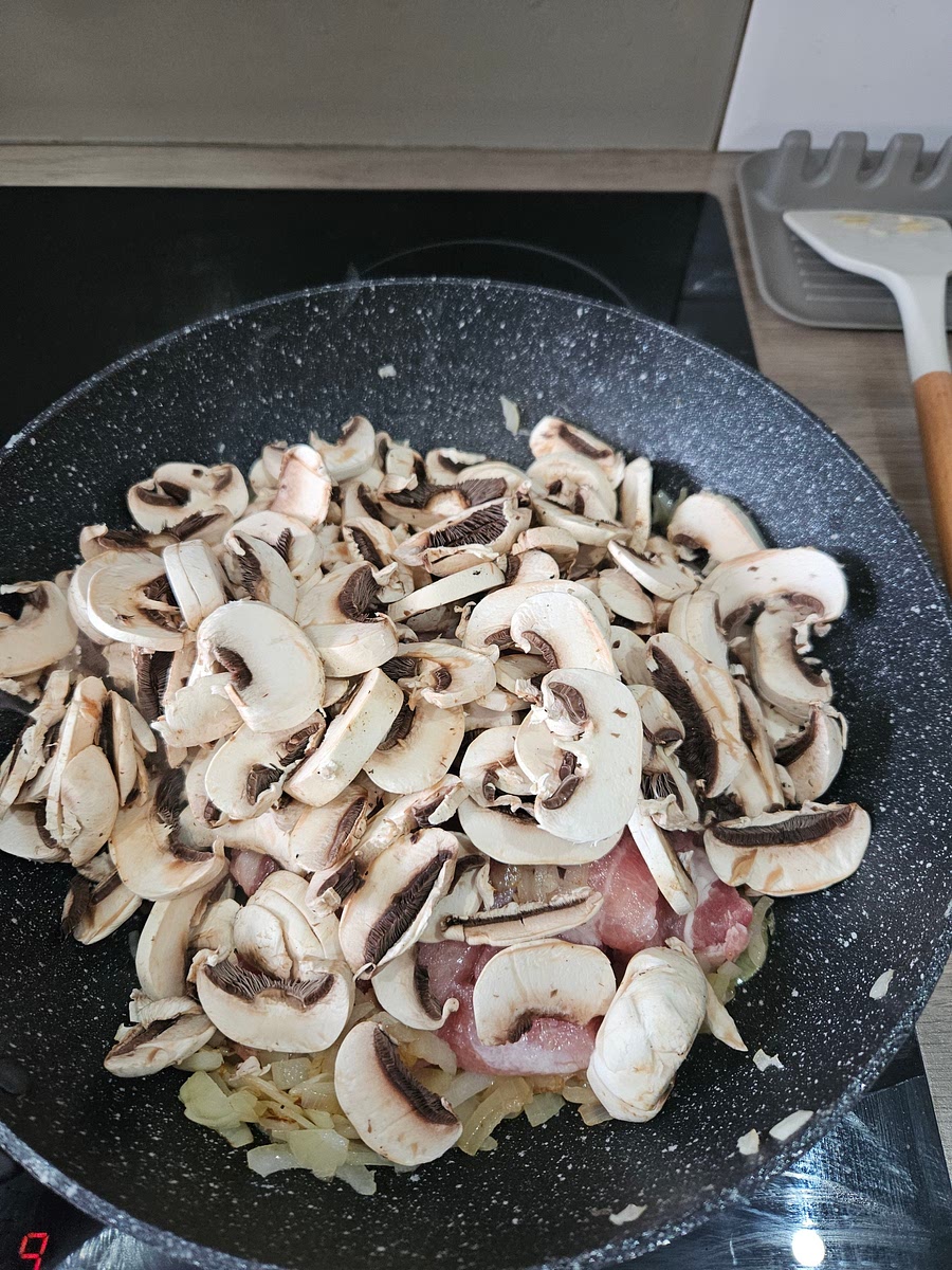 Add pork and mushrooms to onions and cook until browned