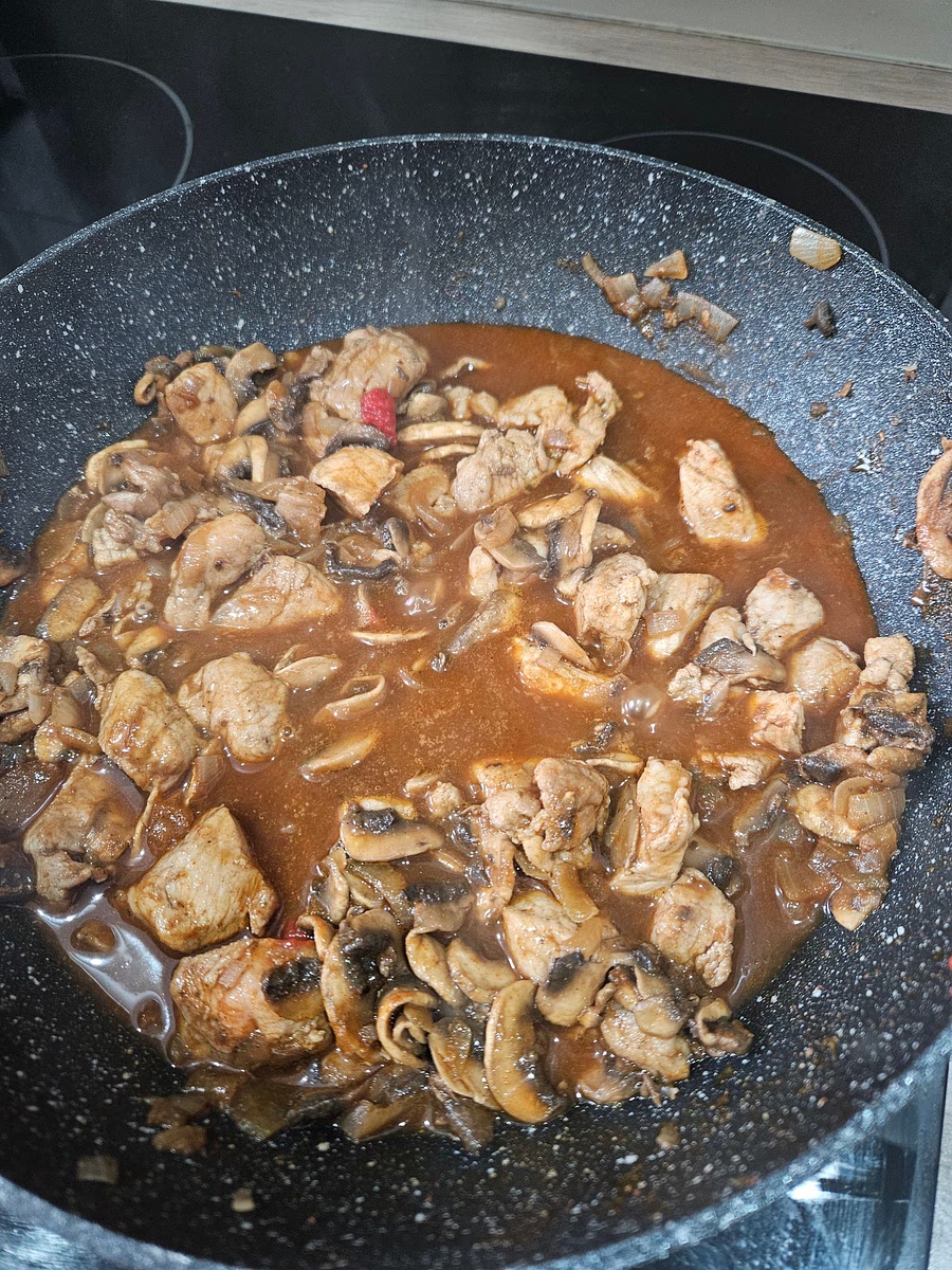 Add chicken stock and tomato puree to pan
