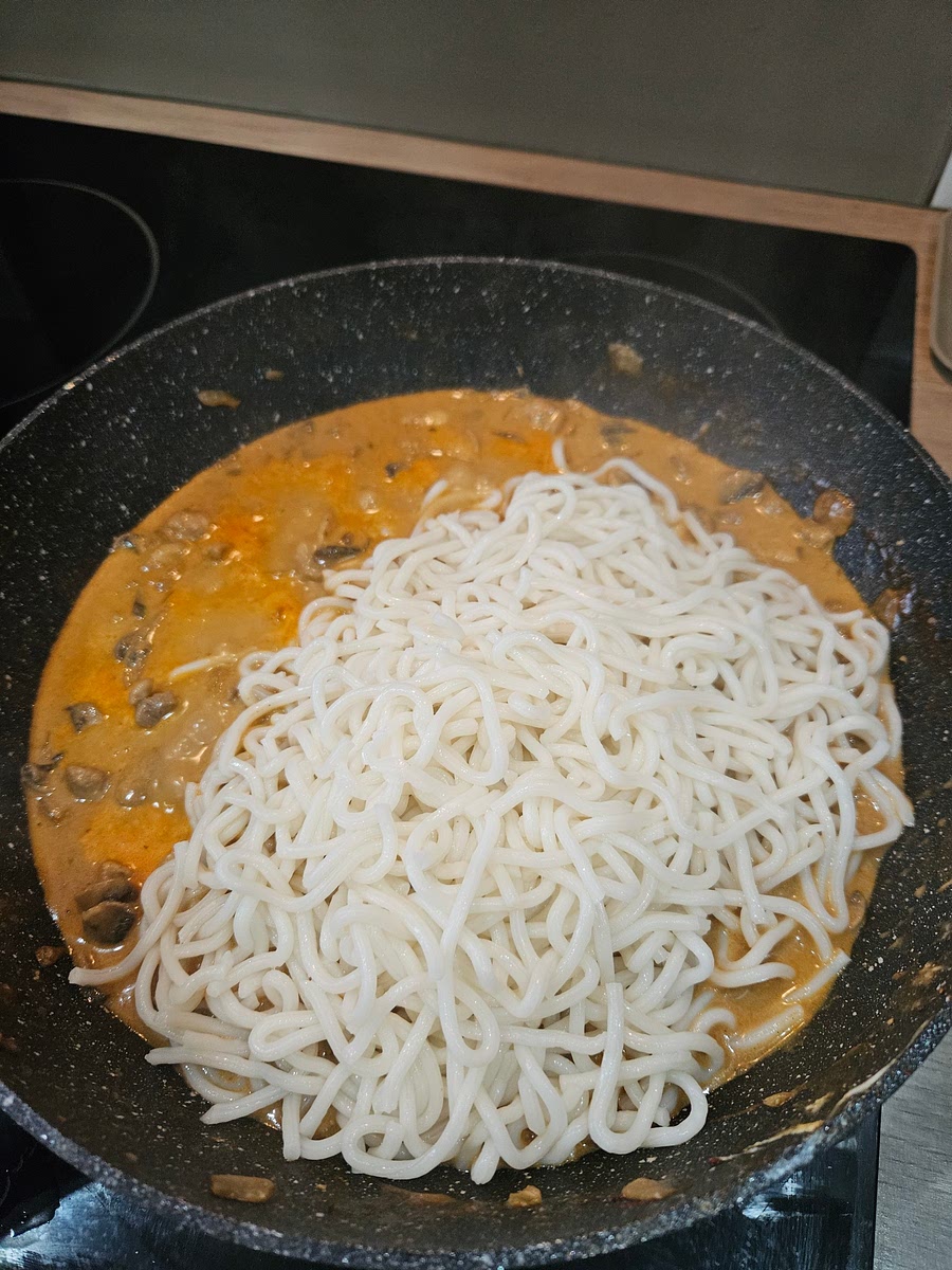Add cooked noodles to pan and coat