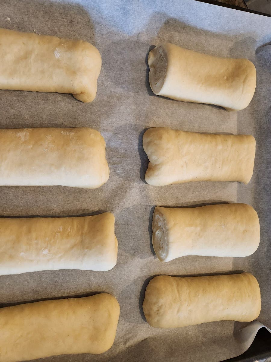 Place each bun about 1/2-inch apart on prepared baking sheet. Cover loosely with a clean kitchen towel and let rise until puffy, about 1-2 hours depending on the dough temperature.