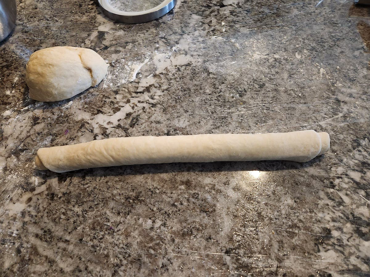 Roll out each half separately with a rolling pen to about 1/8 of an inch thick, a rectangle or square shape. No need to be perfect in the shape. Then roll the dough tightly into a log. This will create nice layers in the rolls