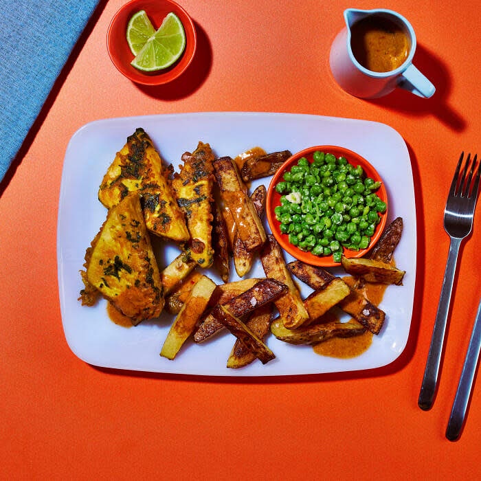 Return the Thai red curry sauce to a low heat to reheat gently. Serve the tofish with the chunky chips, coconut & lime mushy peas and Thai red curry sauce to the side. Garnish with a lime wedge.
