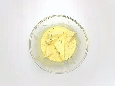 When the chips are almost done, drain the tofu, and cut the block[s] into three then each third in half again on a diagonal to create 6 [12] pieces. Pat the tofu pieces dry with kitchen paper, sprinkle with flour, then tap off any excess. Dip the floured tofu into the batter and turn it several times until fully coated.