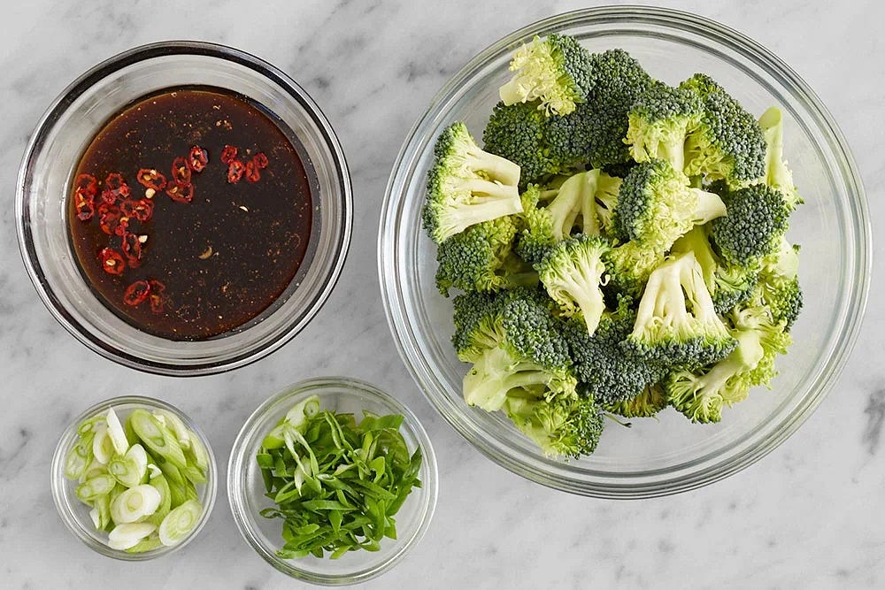 Meanwhile, wash and dry the fresh produce. Cut off and discard the bottom 1/2 inch of the broccoli stem; cut the broccoli into small florets. Thinly slice the scallions on an angle, separating the white bottoms and hollow green tops. Cut off and discard the stem of the pepper; thinly slice crosswise (for a milder dish, discard the ribs and seeds). Thoroughly wash your hands immediately after handling. In a bowl, combine the black vinegar, hoisin sauce, sesame oil, sugar, remaining soy sauce, 2 tablespoons of water, and as much of the sliced pepper as you'd like, depending on how spicy you'd like the dish to be.
