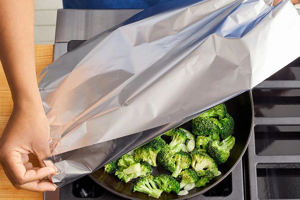 In a medium pan (nonstick, if you have one), heat a drizzle of olive oil on medium-high until hot. Add the broccoli florets; season with salt and pepper. Cook, stirring occasionally, 3 to 4 minutes, or until lightly browned. Add the sliced white bottoms of the scallions and 1/4 cup of water (carefully, as the liquid may splatter). Loosely cover the pan with foil and cook, without stirring, 3 to 4 minutes, or until the broccoli is tender and the water has cooked off. Transfer to a bowl. Cover with foil to keep warm. Wipe out the pan.