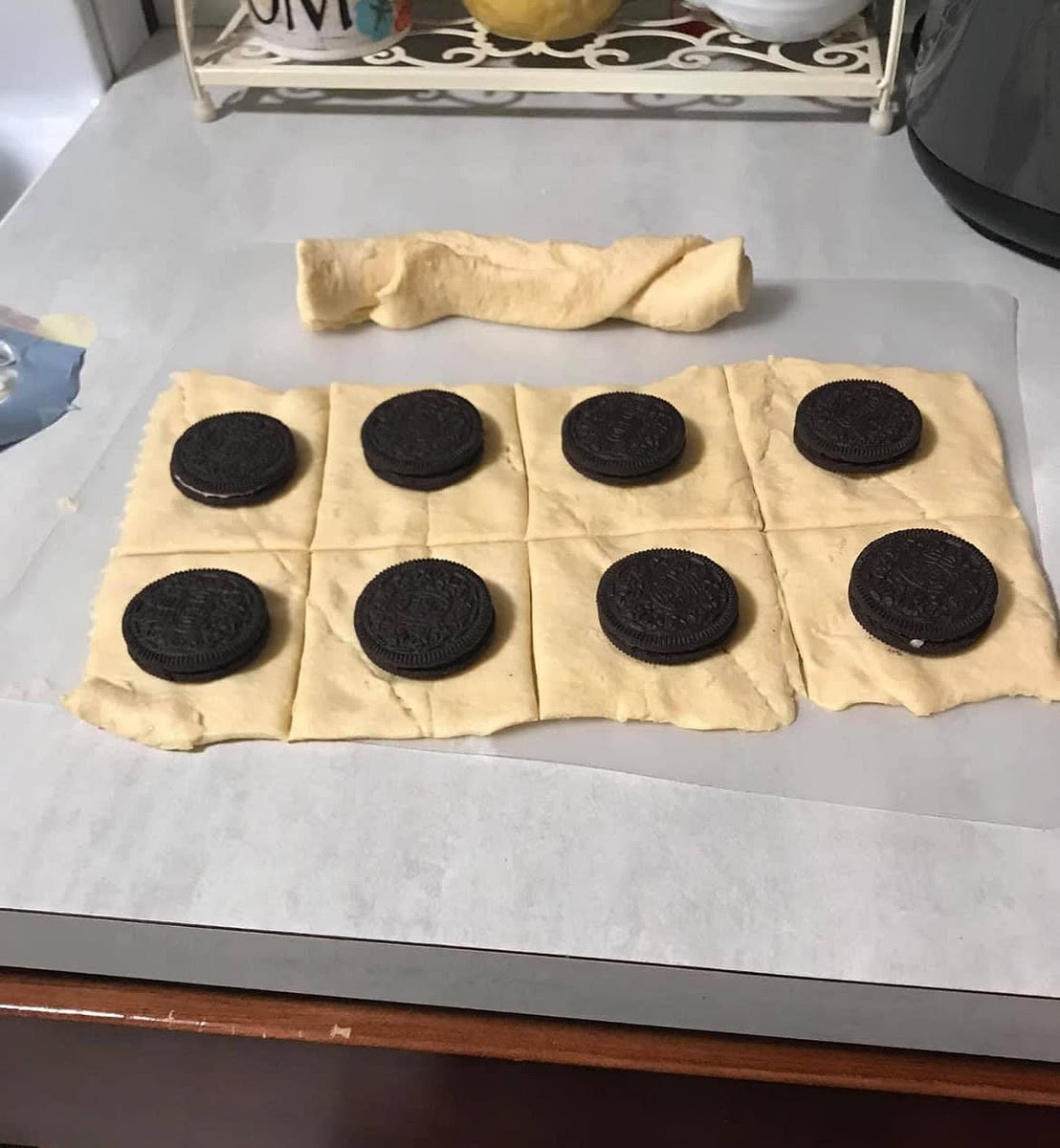 Put one Oreo on each square of the crescent rolls