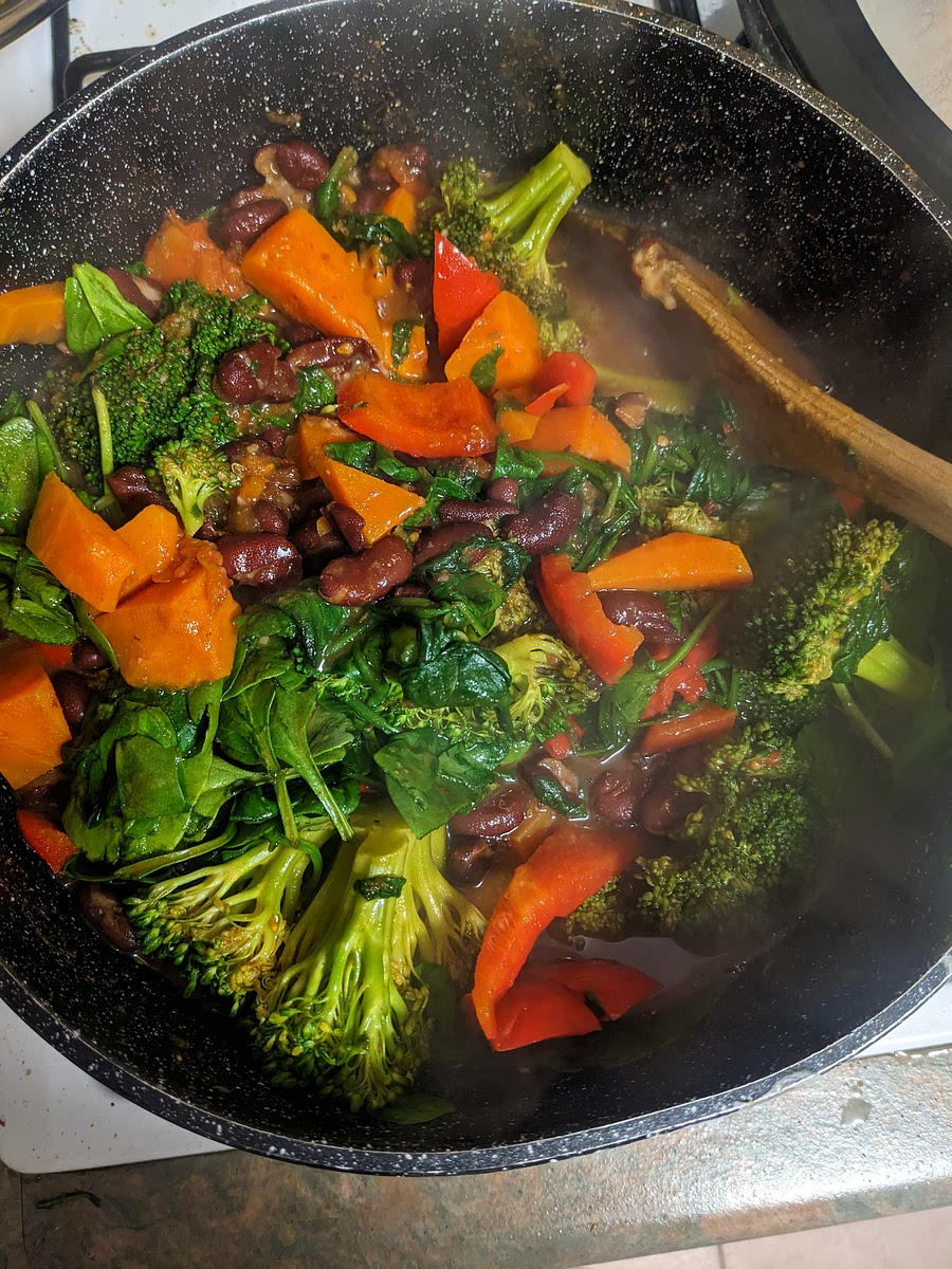 Add chopped broccoli, capsicum, sweet potato, and kale to the stew. Ensure broccoli is submerged. Put a lid on the pot to keep moister in.
