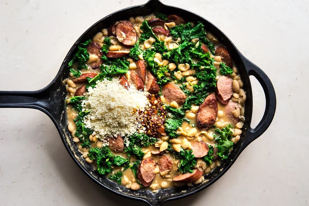 Add the parmesan, lemon and sausage to the pan. Stir to combine. Add remaining stock a little at a time if you need more creaminess. Adjust seasoning to taste.