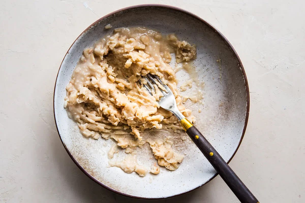 Add the garlic to the pan and cook until fragrant, about 15 seconds. Add ⅔ of the beans and 1 cup of chicken stock to the skillet and season with salt, pepper and thyme, stir to combine and bring to a simmer over medium heat.