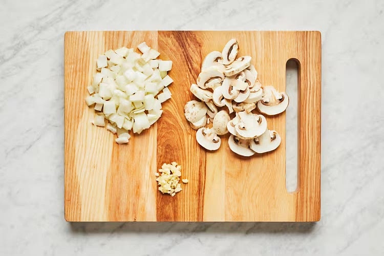 • In a medium pot, combine 4 cups water (7 cups for 4 servings) and stock concentrates. Bring to a boil, then reduce to a low simmer. • Wash and dry produce. • Trim and thinly slice mushrooms (skip if your mushrooms are pre-sliced!). Halve, peel, and dice onion. Peel and mince or grate garlic.