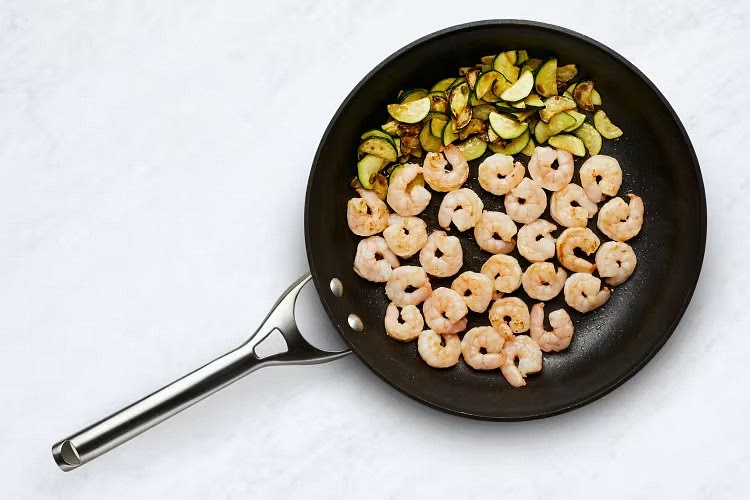 • Push zucchini mixture to one side of pan; add a large drizzle of olive oil to empty side. • Add shrimp and cook, stirring occasionally, until opaque and cooked through, 3-4 minutes.