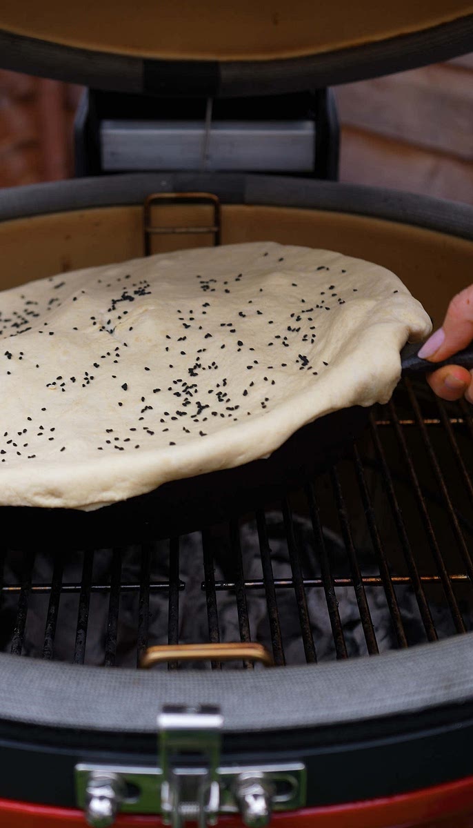 7. Place the skillet back on the grill and cover with the lid. Bake until the dough is golden and cooked through, about 30 minutes.