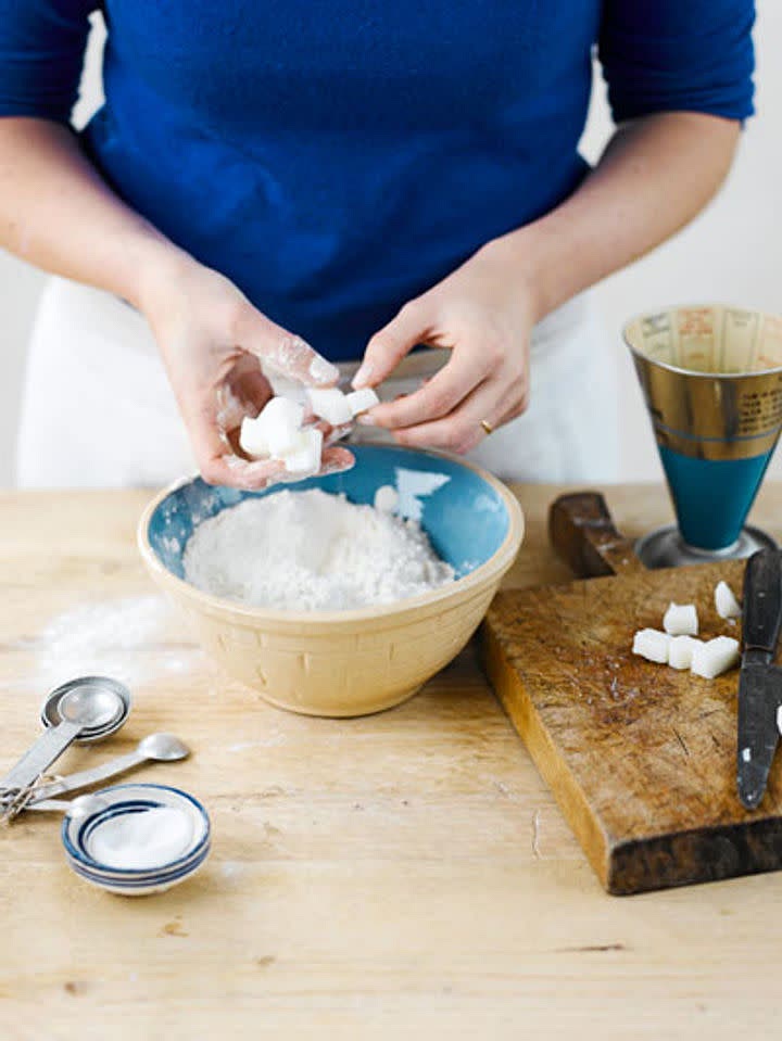 Mix the flour with ¼ of a teaspoon of sea salt in a bowl, then cube and rub in the lard with your fingers until it resembles breadcrumbs.