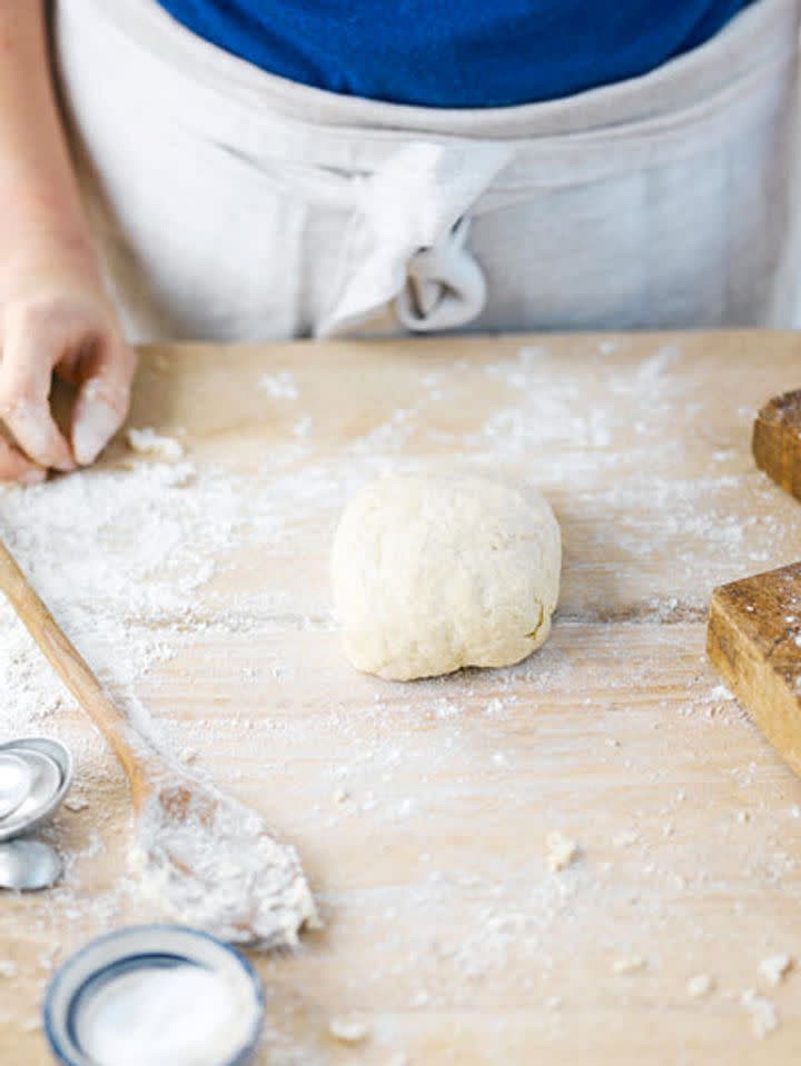 The butter needs to be cold, but soft enough to be malleable. Remove it from the fridge and place it between two sheets of greaseproof paper. Using a rolling pin, roll it out to about 14cm x 16cm.
