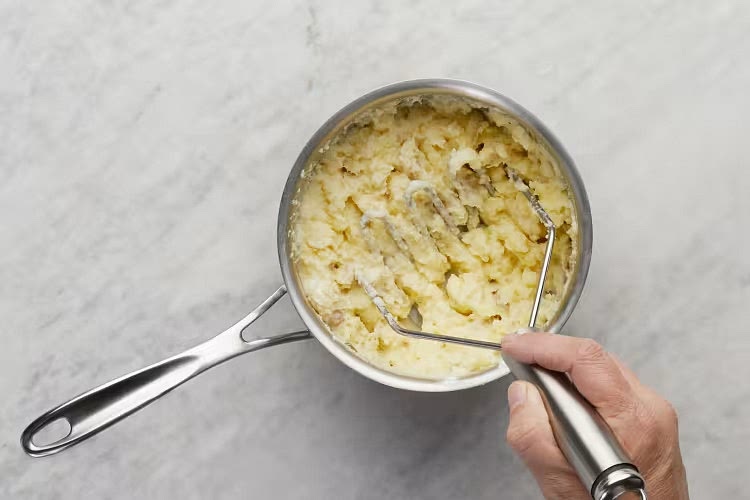 • Dice potatoes into 1⁄2-inch pieces. Place in a medium pot with enough salted water to cover by 2 inches. Bring to a boil; cook until tender, 15-20 minutes. Reserve 1⁄2 cup potato cooking liquid, then drain. • Heat a drizzle of oil and scallion whites in empty pot over low heat; cook until softened, 1 minute. Return potatoes to pot; mash with remaining sour cream and 1 TBSP butter (2 TBSP for 4 servings) until smooth and creamy, adding splashes of reserved potato cooking liquid as needed. Season with salt and pepper. Keep covered off heat until ready to serve.