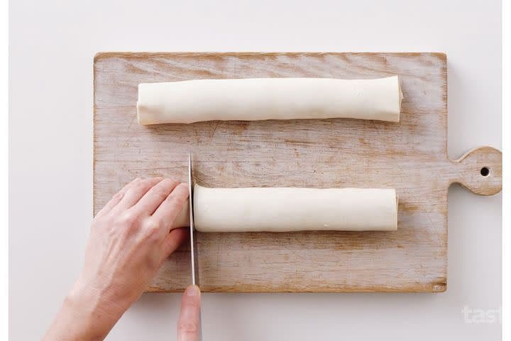 Lay a sheet of pastry on a flat surface. Cut sheet in half horizontally. Spoon 1/8 of the mince mixture down along the long side of one pastry half, shaping mince into a long sausage shape. Brush opposite long edge with a little egg mixture.