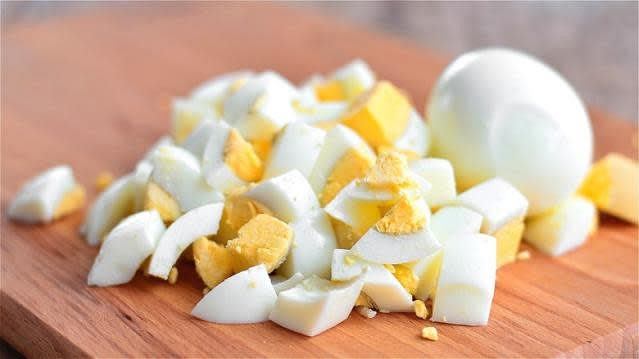 Peel the cooled eggs and chop them into small pieces.