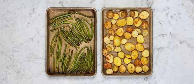 Once potatoes have roasted 8 minutes, toss green beans on a second baking sheet with a drizzle of oil, salt, and pepper. Roast until green beans are tender and potatoes are golden brown and crispy, 10-12 minutes.