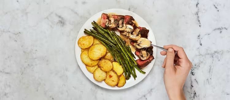 Thinly slice steak against the grain. Divide steak, green beans, and potatoes between plates. Spoon mushroom sauce over steak.