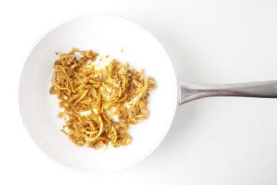 Meanwhile, chop your creamed coconut roughly (if required!).
Dissolve your stock mix, chopped creamed coconut and a large pinch of sugar in 500ml boiled water – this is your coconut stock.
Once the onion has softened, add your ground turmeric, curry powder and chopped garlic and cook for 1-2 min further or until fragrant