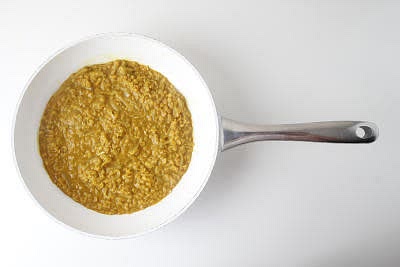 Once fragrant, rinse your red lentils in a sieve under cold running water
Add the rinsed lentils to the pan with the coconut stock
Reduce the heat to medium-low and cook for 25-30 min or until the lentils are almost cooked and the sauce has thickened