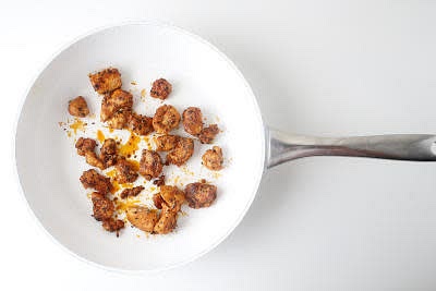 Heat a separate large, wide-based pan (preferably non-stick) with a drizzle of vegetable oil over a high heat.
Once hot, add the marinated chicken and cook for 7-8 min.
Add your cider vinegar and cook for 3-4 min further or until cooked through (no pink meat!) – this is your paprika chicken.
Add your garlic & coriander naan[s] to a toaster for 1-2 min or until warmed through